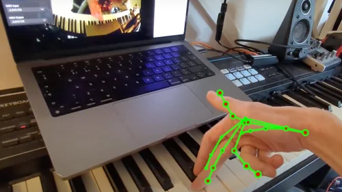 Hand Tracking skeleton overlaid on hand playing piano